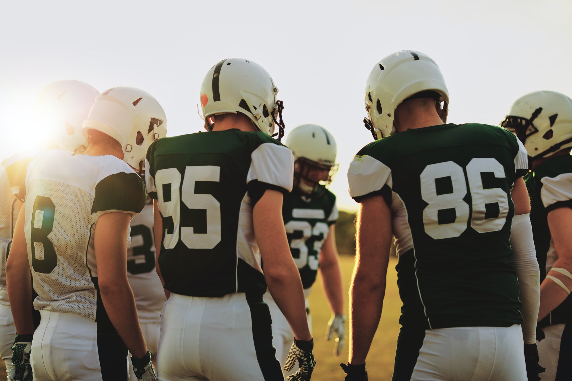 american-football-players-standing-in-a-huddle-before-a-game.jpg